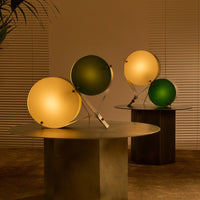 "Modern lamp set with soft yellow and deep green orbs on sleek metallic bases, creating a chic, contemporary look."