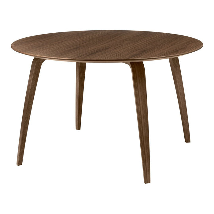 Round wooden table in rich walnut finish with smooth, solid surface and tapered legs, perfect for modern decor.