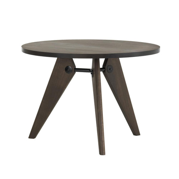 Round wooden table with a dark finish and angled legs, showcasing a sleek, modern design. Ideal for minimalistic decor.