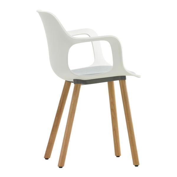 Modern white chair with smooth curves and natural wood legs, featuring a minimalist design. Perfect for contemporary spaces.