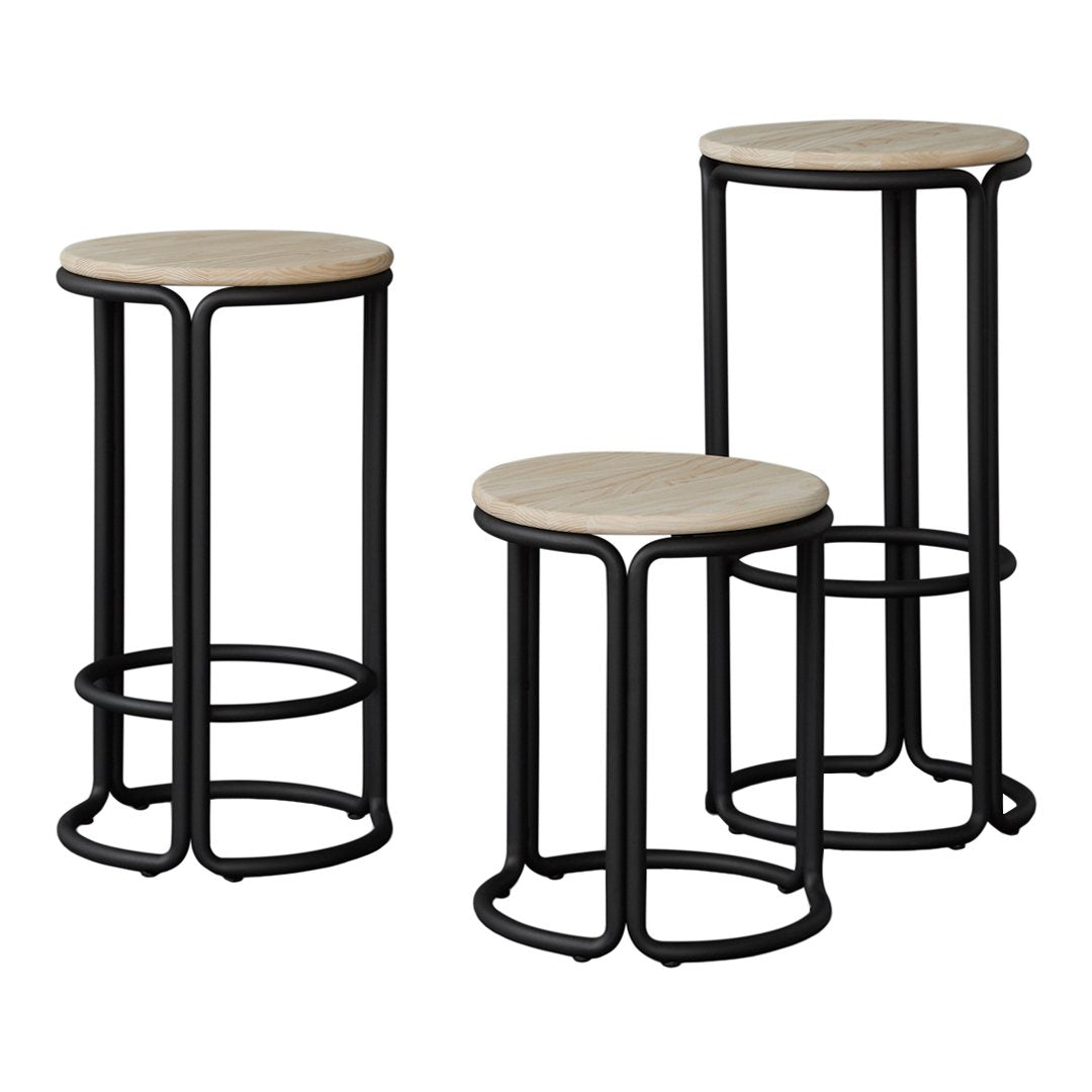 "Set of three minimalist stools with natural wood tops and sleek black metal frames."