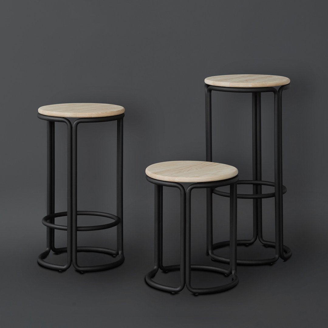 Set of three black metal stools with natural wood tops, featuring clean lines and a minimalist design.