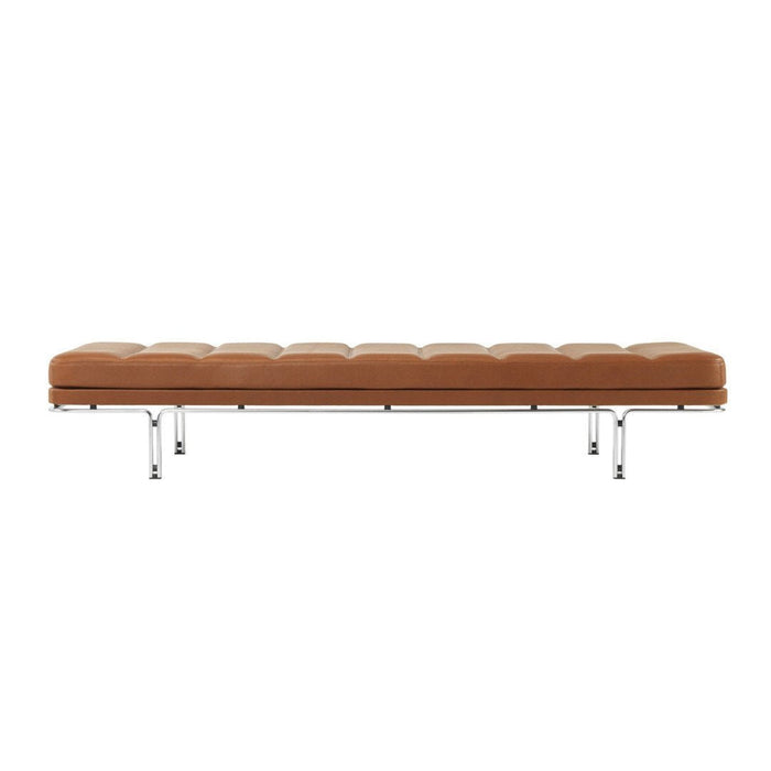 Brown leather bench with tufted design and sleek chrome legs, perfect for modern decor.