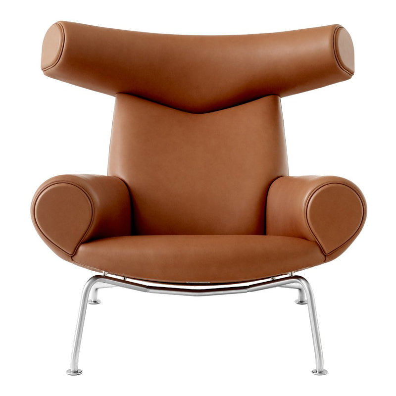 Brown leather armchair with sleek chrome legs and rounded, modern design. Perfect for contemporary interiors.