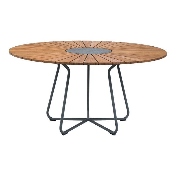 Round wooden dining table with a natural wood finish, featuring a geometric pattern and a black metal base.