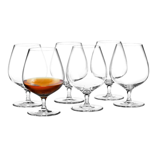 Set of six crystal-clear glasses showcasing elegant curves, with one glass filled with amber liquid.