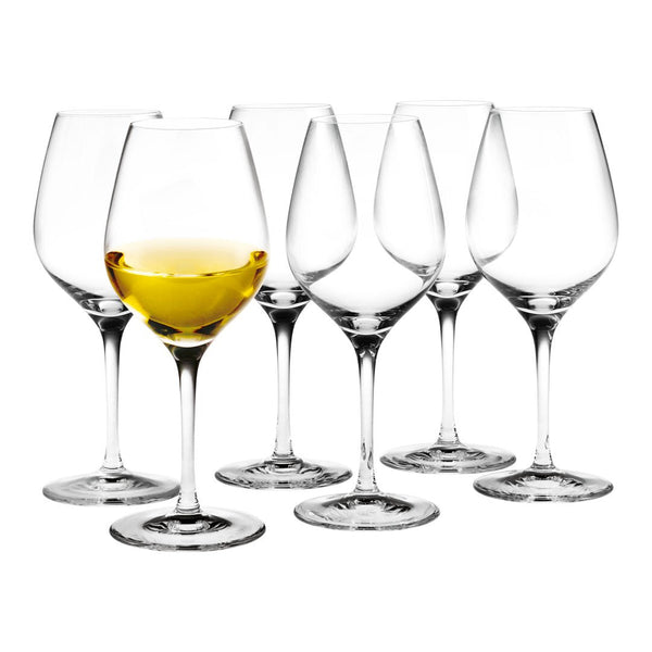 Set of six elegant clear wine glasses with a single filled glass showcasing a golden yellow beverage.