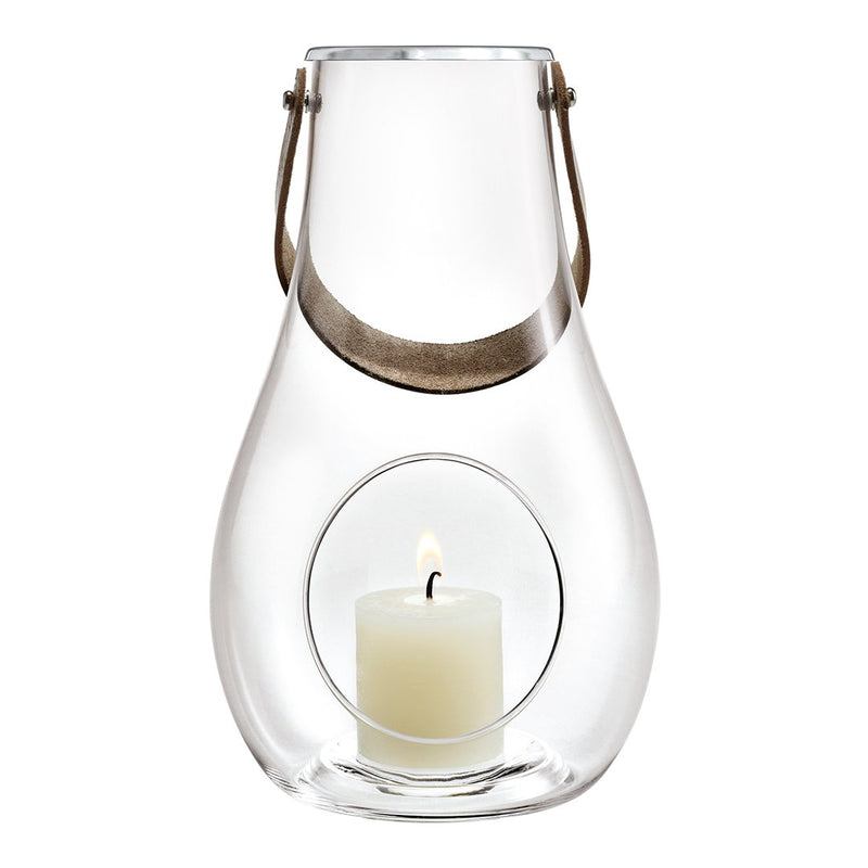 Clear glass lantern with a silver handle and a white candle inside, featuring a minimalist design and smooth contours.