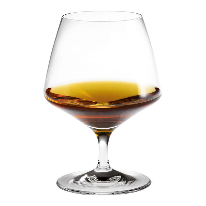 Elegant crystal glass filled with rich amber liquid, showcasing a smooth gradient from gold to deep brown.