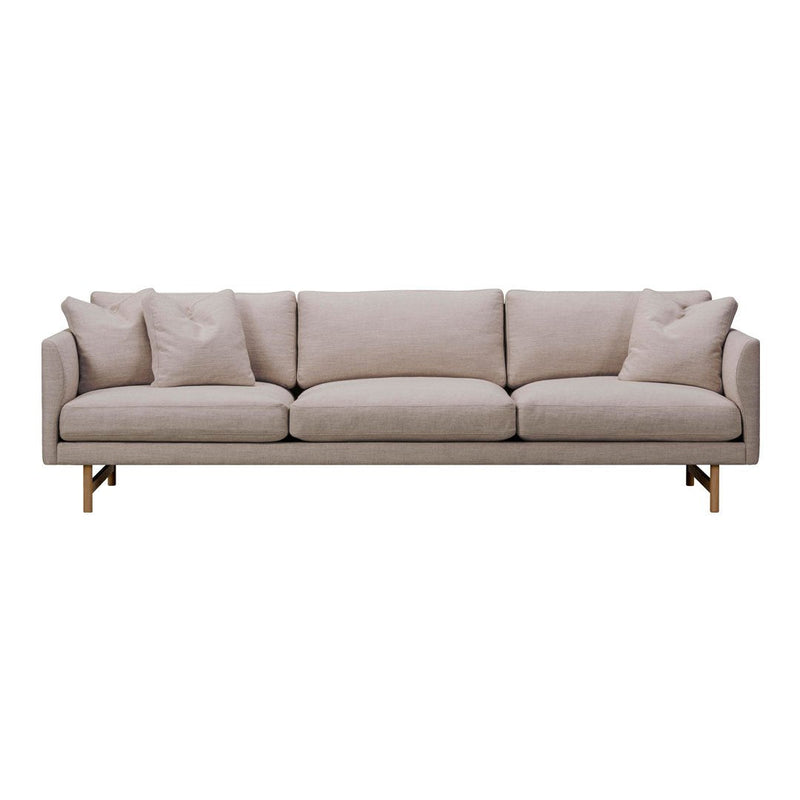 Light beige sofa with smooth fabric and subtle texture, featuring clean lines and minimalist design, adorned with plush pillows.