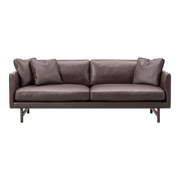 Brown leather sofa with sleek design and smooth texture, featuring plush cushions for added comfort.