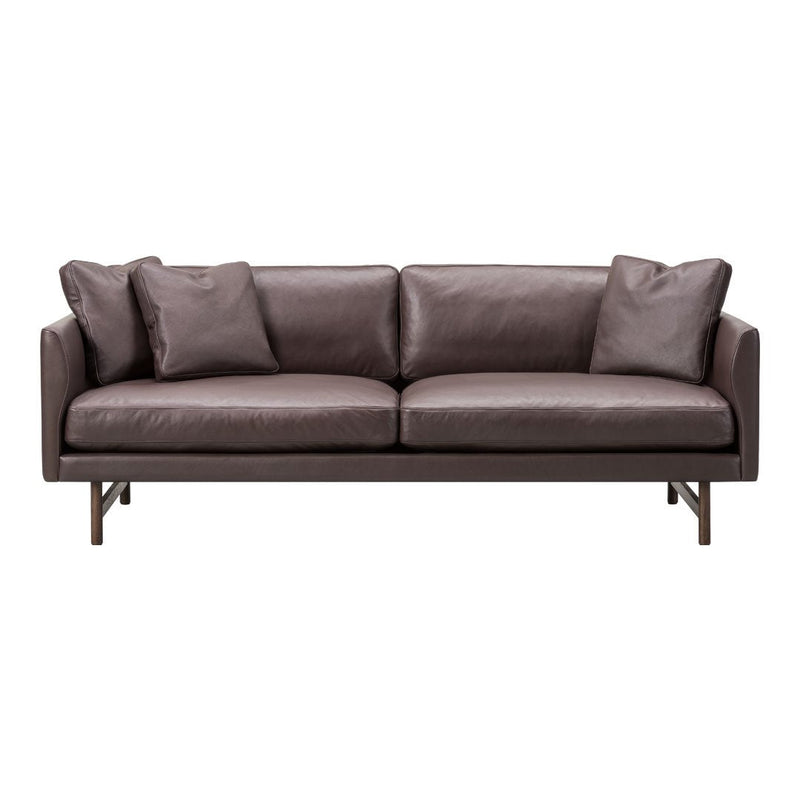 Brown leather sofa with sleek design and smooth texture, featuring plush cushions for added comfort.