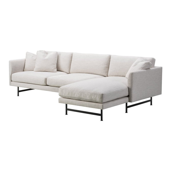Modern sectional sofa in a soft beige fabric, featuring clean lines and minimalistic black metal legs.