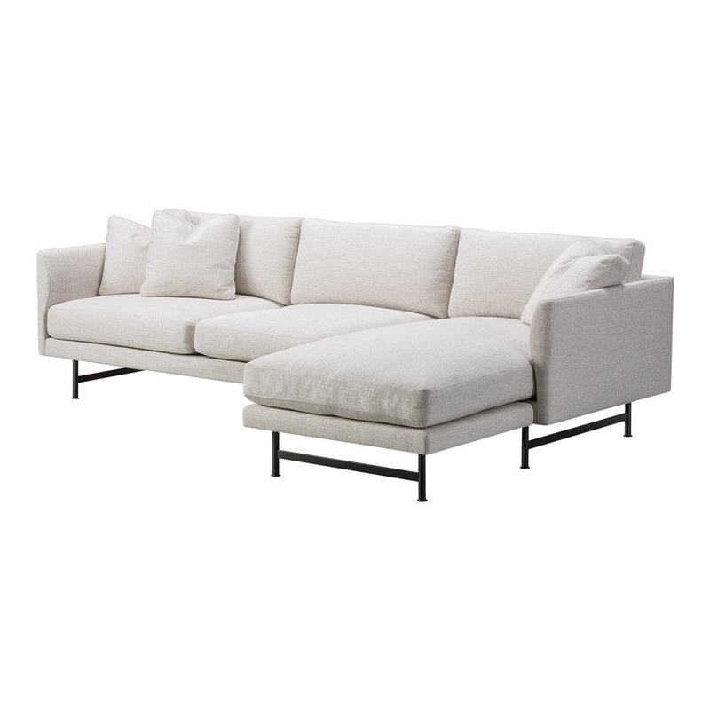 Modern sectional sofa in a soft beige fabric, featuring clean lines and minimalistic black metal legs.
