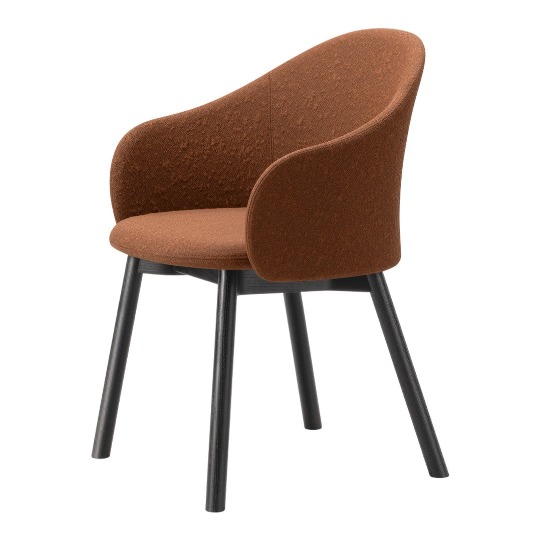 Rust-colored upholstered chair with textured fabric and sleek black wooden legs, perfect for modern decor.