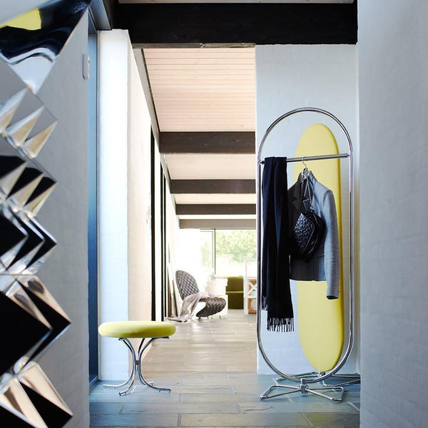 Modern hallway with yellow accents, sleek gray walls, and shiny metallic elements. Stylish minimalist decor.
