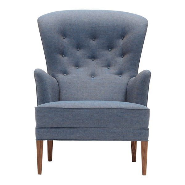 Light blue tufted accent chair with sleek wooden legs and a modern silhouette, perfect for stylish interiors.