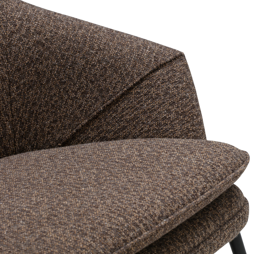 Brown textured upholstery with a subtle woven pattern, featuring a modern, angular design. Ideal for stylish decor.