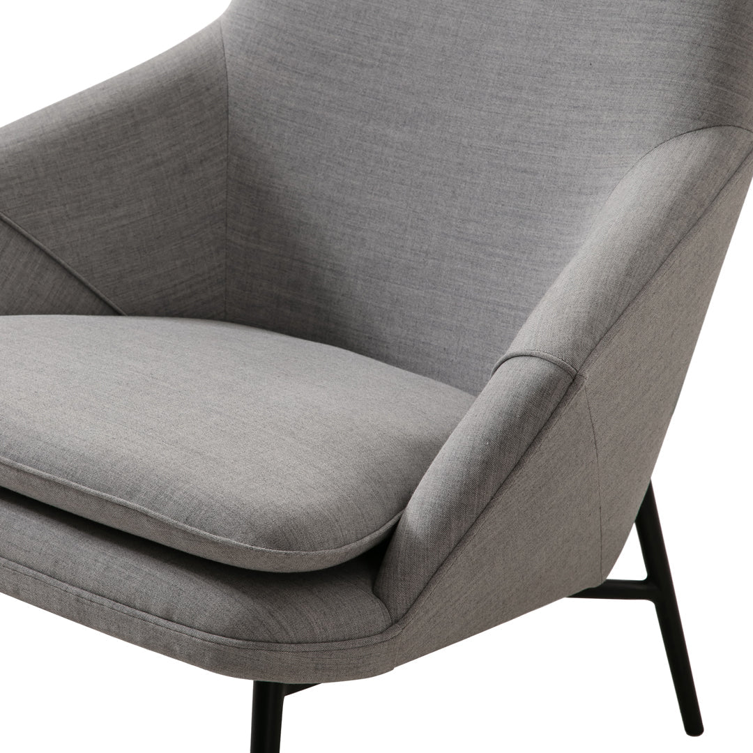Stylish gray accent chair with smooth fabric and clean lines, perfect for modern home decor.
