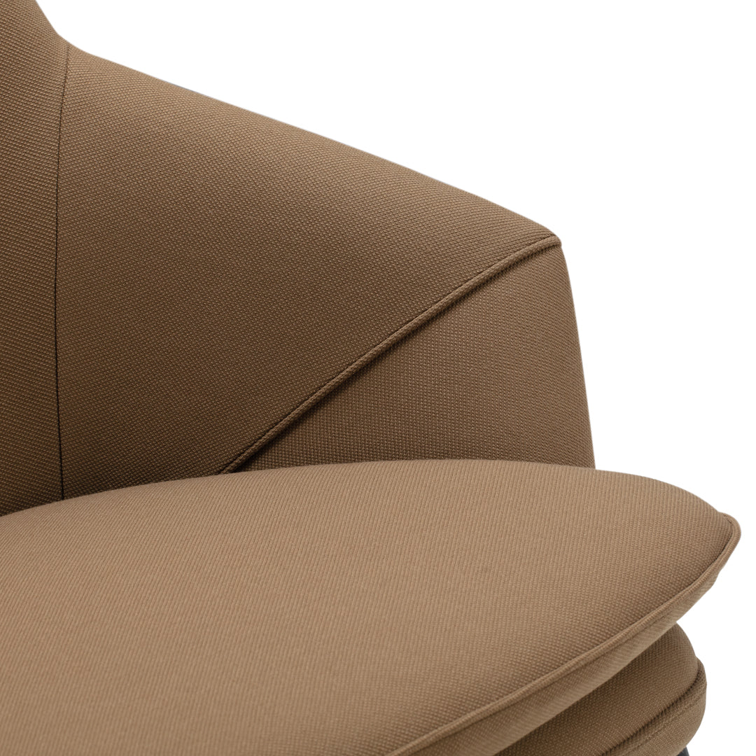 Brown upholstered chair with smooth, curved lines and a modern design. Soft, neutral tones suitable for various interiors.