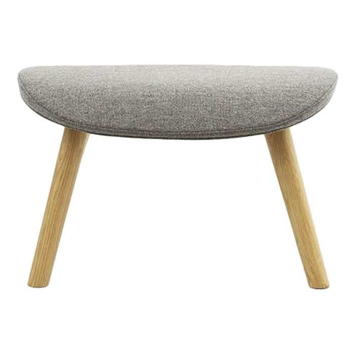 Gray upholstered ottoman with a rounded top and natural wood legs, featuring a simple, modern design.