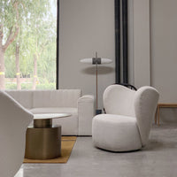 White textured chair with rounded edges, accentuating modern minimalism in a neutral-toned living space.