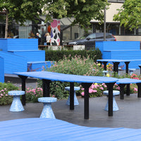 Vibrant blue furniture with decorative flower patterns in a colorful outdoor setting. Ideal for lively garden spaces.