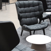 "Stylish dark gray upholstered chair with a quilted pattern, set against a neutral backdrop."