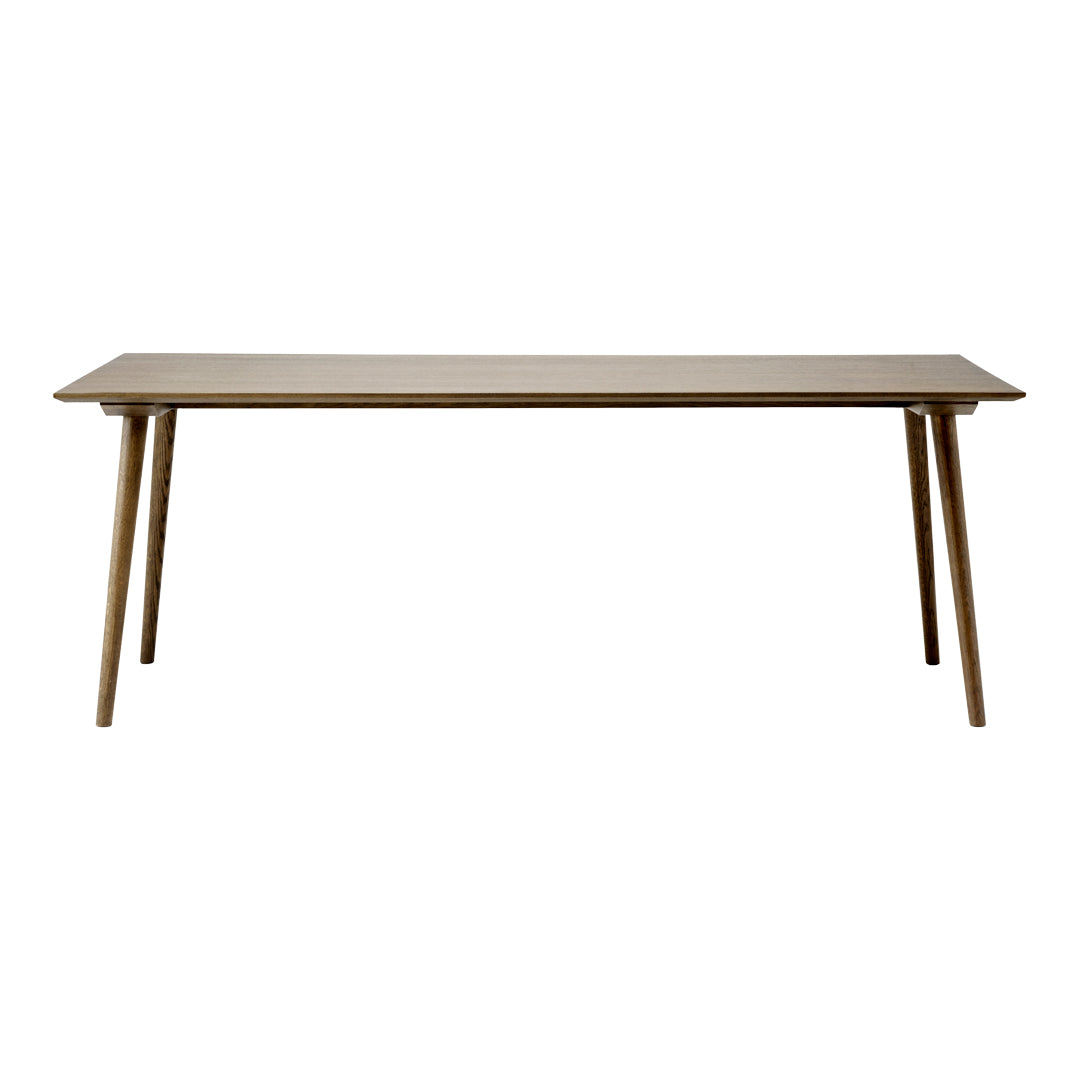 Light brown rectangular table with smooth surface and tapered wooden legs, showcasing a minimalist design.
