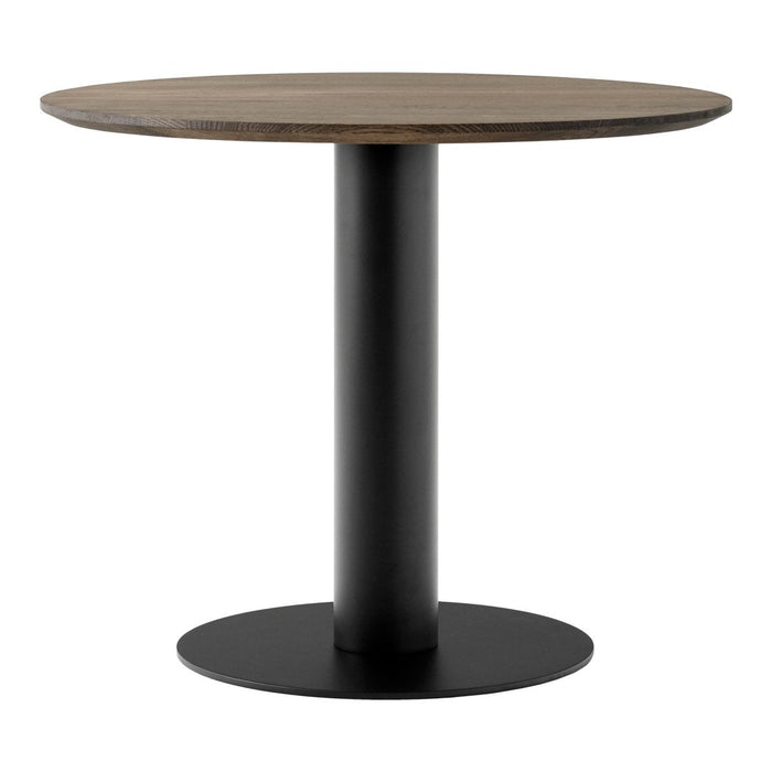 Modern round dining table with a rustic wood top and sleek black metal base, featuring simple, clean lines.