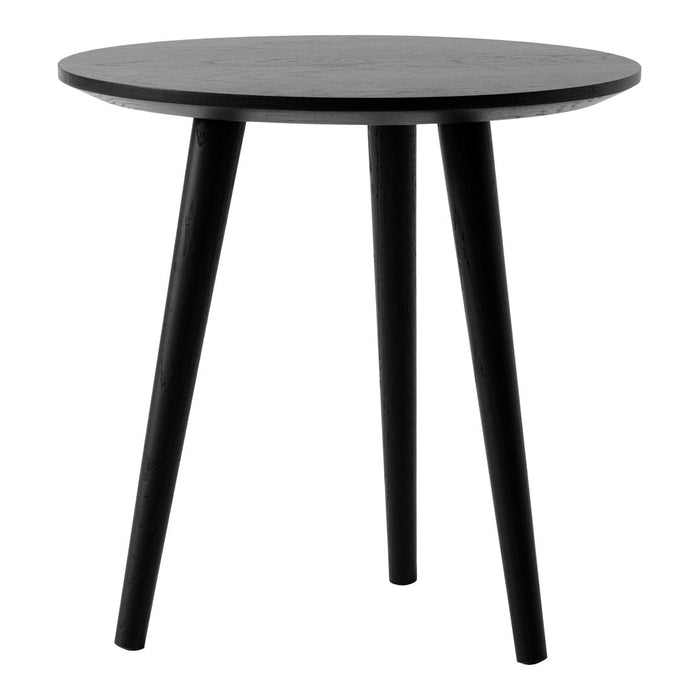Round black side table with sleek, minimalist design and tapered legs. Perfect for modern decor.