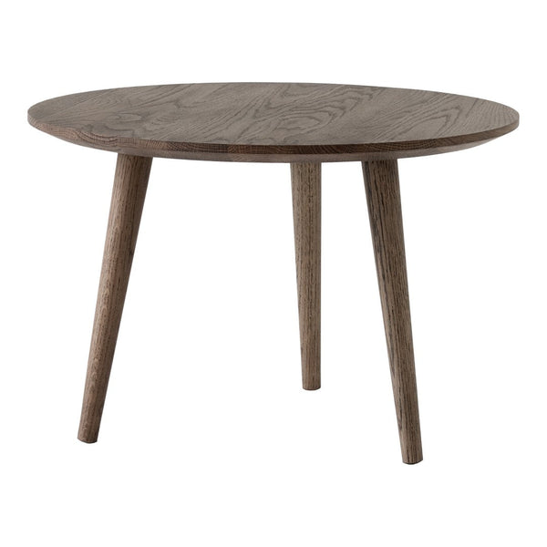 Round wooden table with a smooth, dark brown finish and natural wood grain pattern, featuring tapered legs.