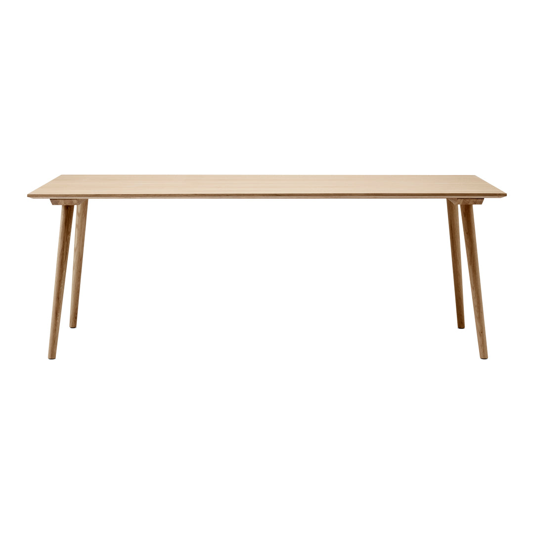 Natural wood finish dining table with a minimalist design and light color. Simple, clean lines enhance any space.