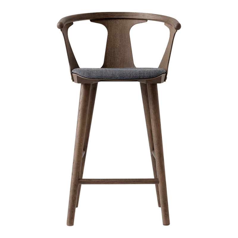 "Natural wood finish bar stool with a gray upholstered seat, showcasing a modern, minimalist design."