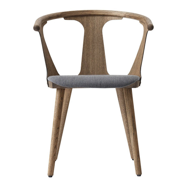 "Natural wood chair with a smooth gray upholstered seat and elegant curvy backrest."