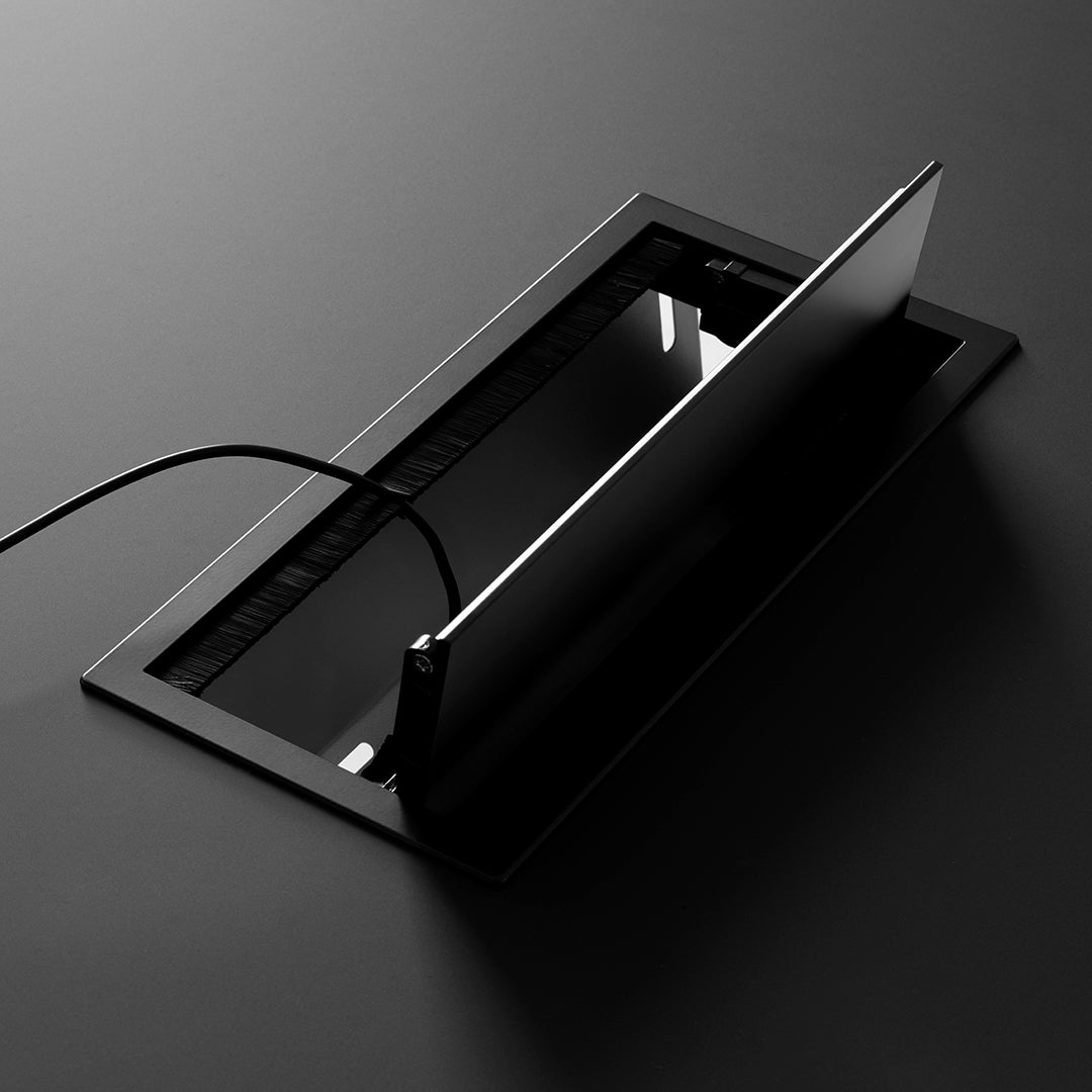 Sleek black cable management box with a glossy finish, featuring minimalistic design and subtle reflective patterns.