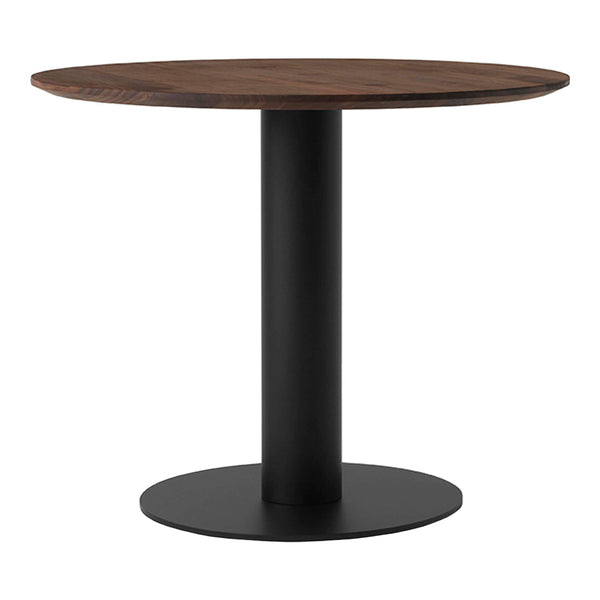 Round wooden dining table with a dark walnut top and sleek black metal base, featuring a minimalist design.