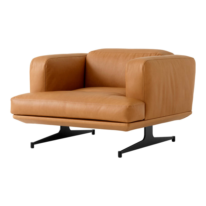 Tan leather armchair with smooth texture and minimalist design, set on sleek black metal legs. Ideal for modern decor.