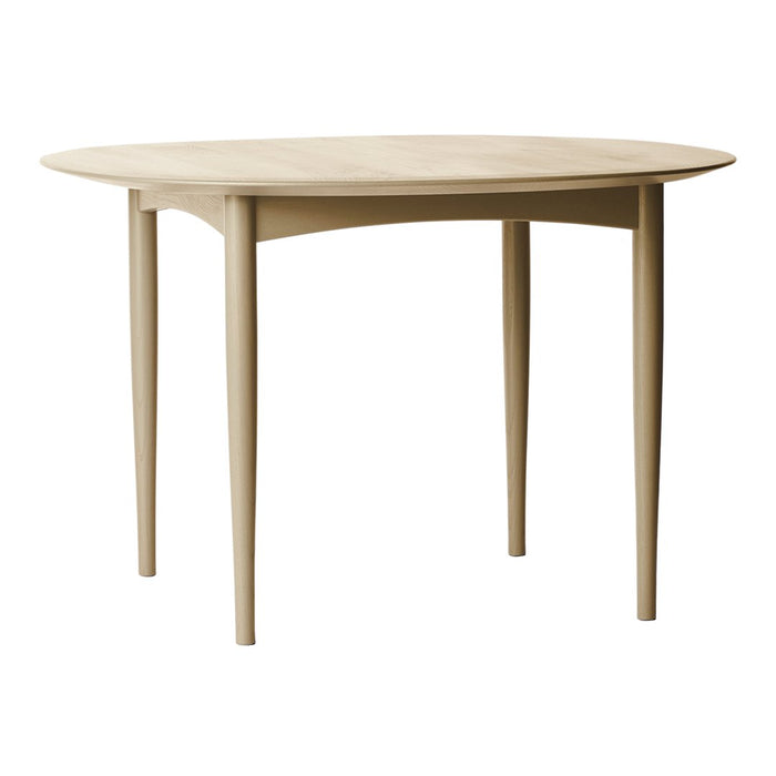 "Light beige round dining table with smooth, simple surface and tapered legs, perfect for modern interiors."