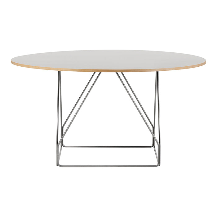 Round dining table featuring a white top and natural wood edge, supported by a sleek silver metal base.