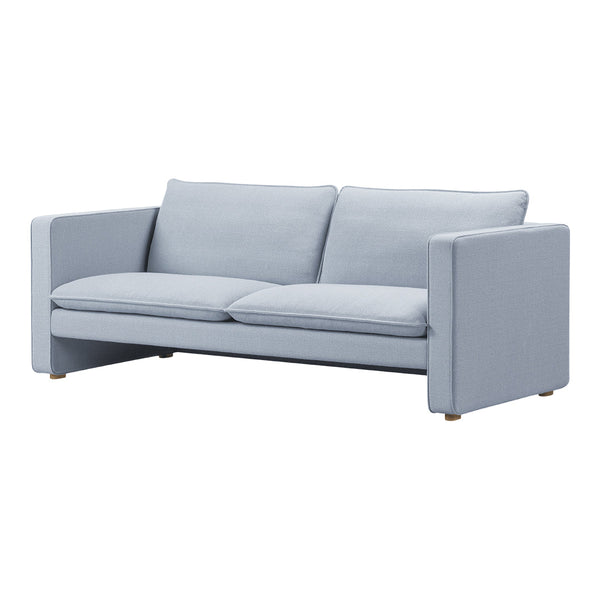 Light blue modern sofa with a minimalist design, featuring soft fabric and solid color upholstery.