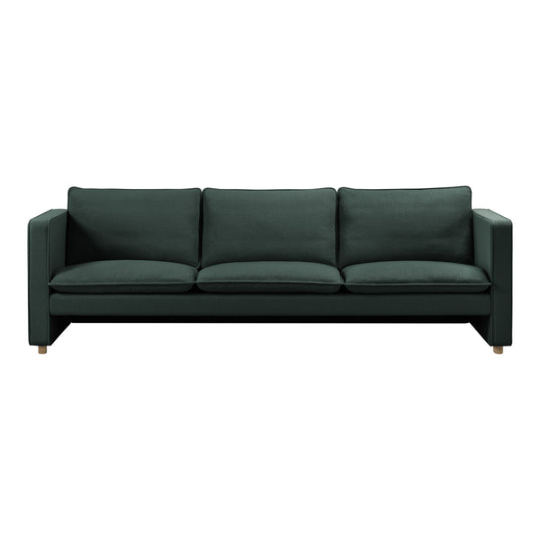 "Dark green upholstered sofa with a sleek design and plush cushions, featuring a minimalist aesthetic."