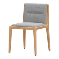 Gray upholstered chair with wooden legs, featuring a minimalist design and soft textures. Perfect for modern interiors.