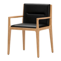 Black upholstered chair with light wood frame, featuring a modern minimalist design and smooth textures.