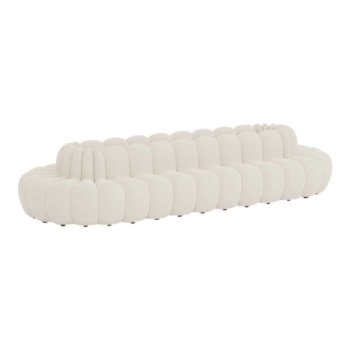 Soft white sofa with a plush, rounded design and subtle textured grooves for a contemporary look.