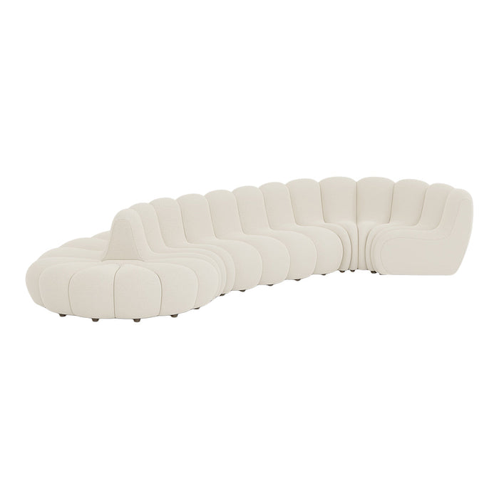 Curved white sofa with plush, ribbed upholstery and smooth, rounded edges for a modern touch.
