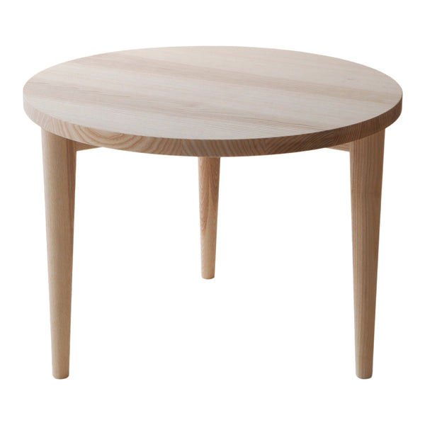 Light wood round table with a smooth, natural finish and tapered legs, featuring a minimalist design and neutral tones.