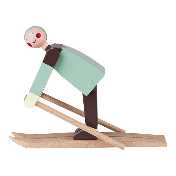 Colorful wooden skier figurine with a mint green body, brown skis, and a playful pink face. Perfect for decor.