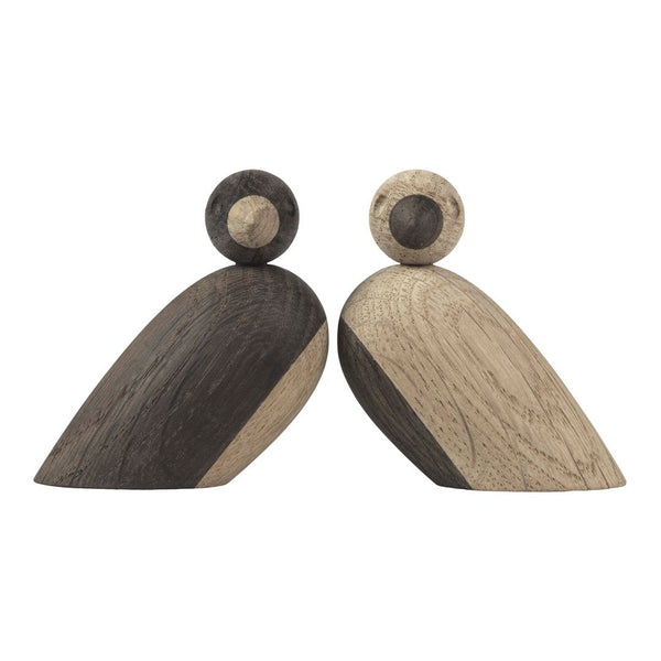 Wooden decorative figures in dark brown and light beige with smooth, curved shapes and contrasting patterns.