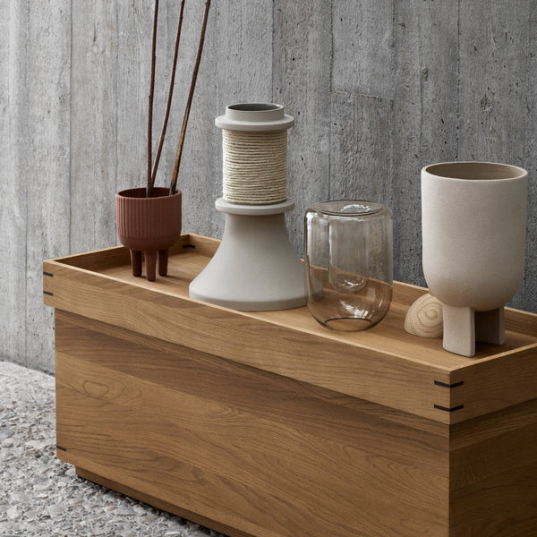 "Natural wood finish with muted earth tones; minimalist ceramics and glass add subtle elegance to a modern tabletop."